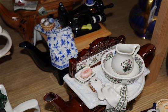 A collection of thirteen Portmeirion and Cardew novelty teapots, including dresser, sewing machine and kitchen range examples